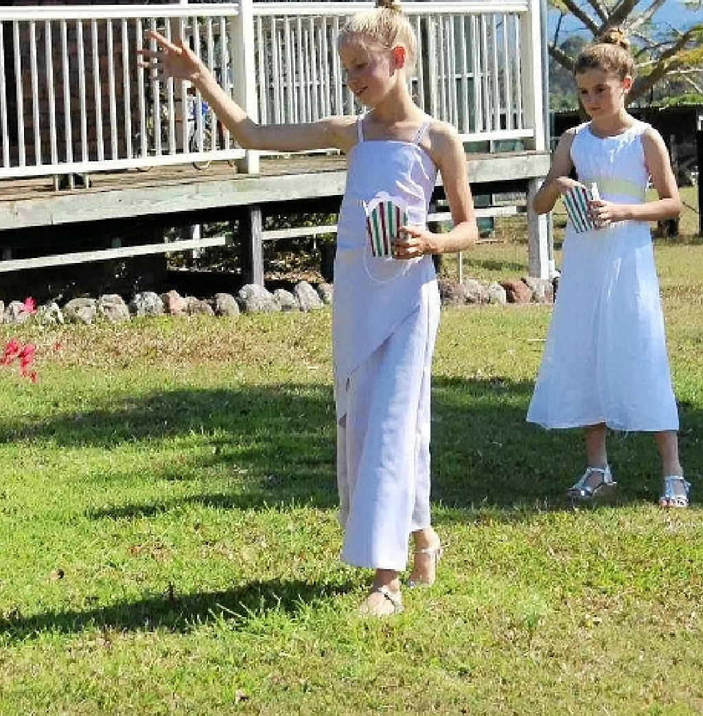 THE CEREMONY: Flowergirls Allie Salter and Lily Bromilow throw petals. THE CEREMONY: Flowergirls Allie Salter and Lily Bromilow throw petals.